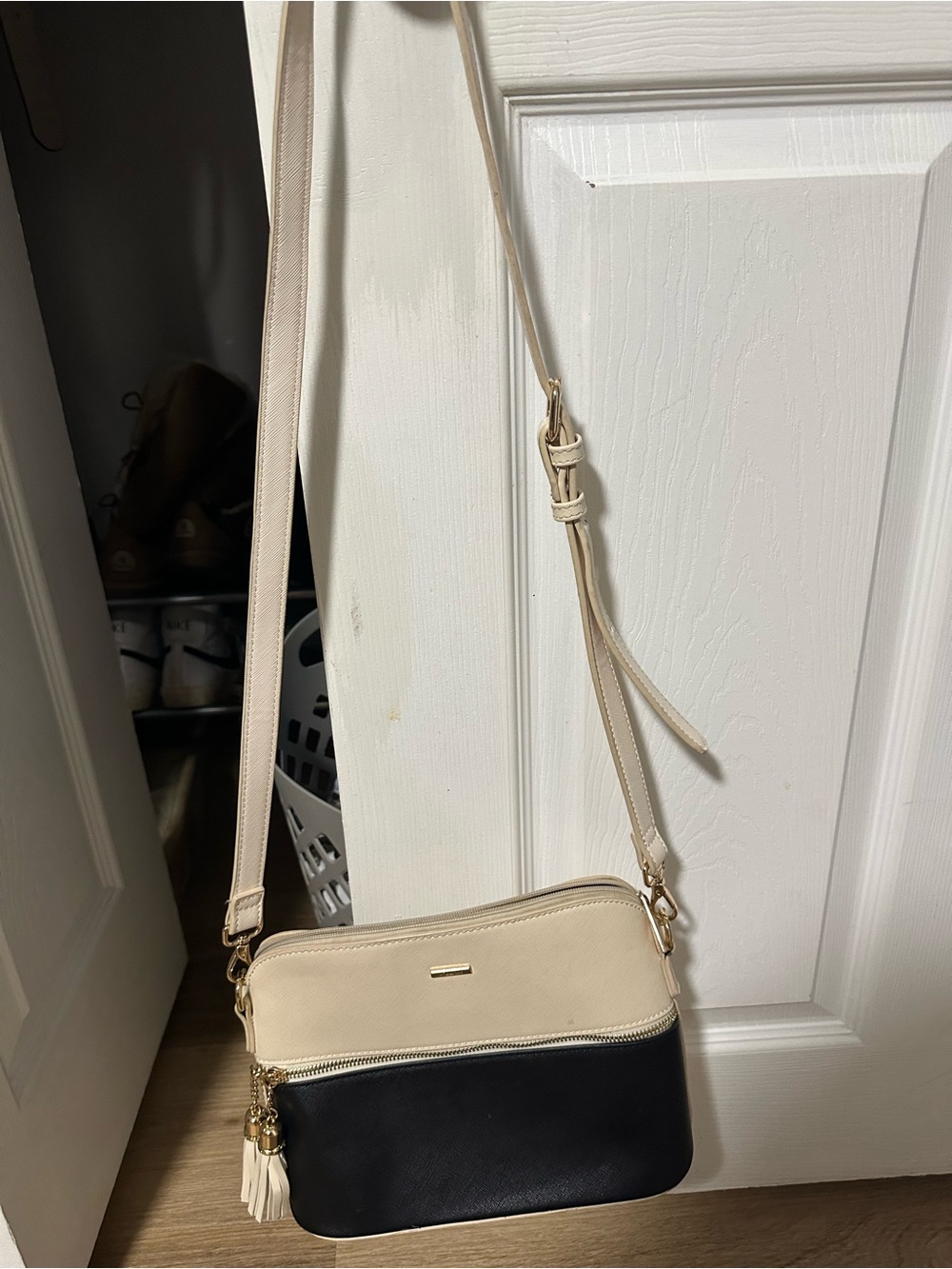 Two-Tone Cream and Black Crossbody Bag with Tassel Accent